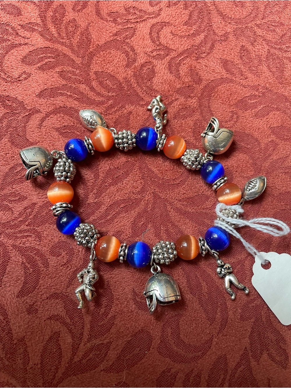 Football bracelet Blue and Orange and charms as shown.